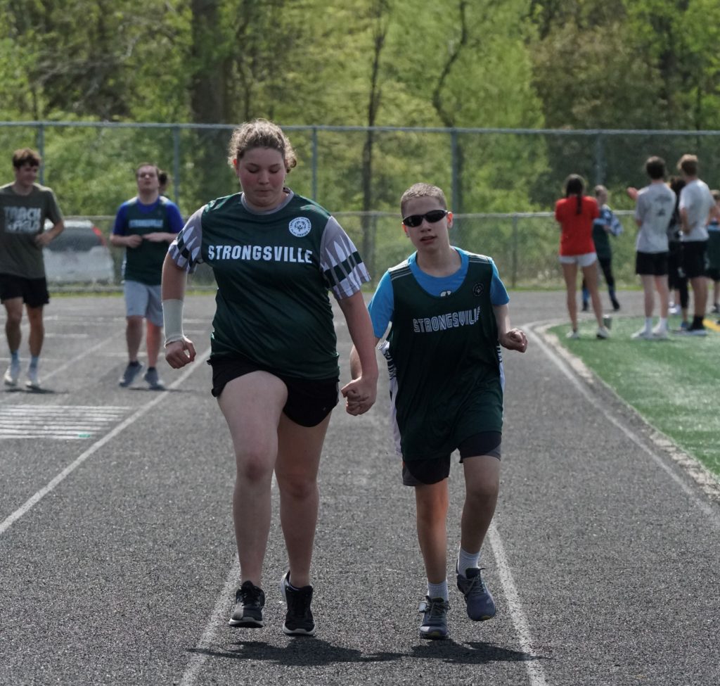 Man playing volleyball wearing yellow shirt | Unified Champion Schools | Special Olympics Ohio 